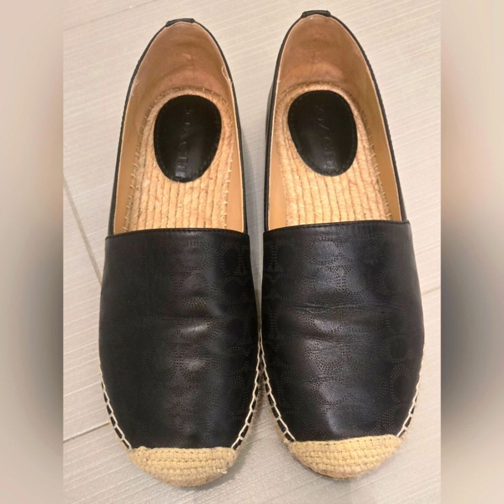 Coach Carley Black leather Espadrille Slip-On Shoes with Coach design on top.